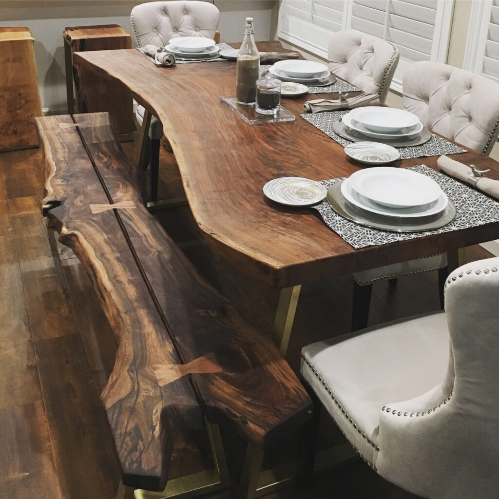 Beautiful dining room featuring a handcrafted live edge table and bench in Ottawa, set for dinner with modern décor