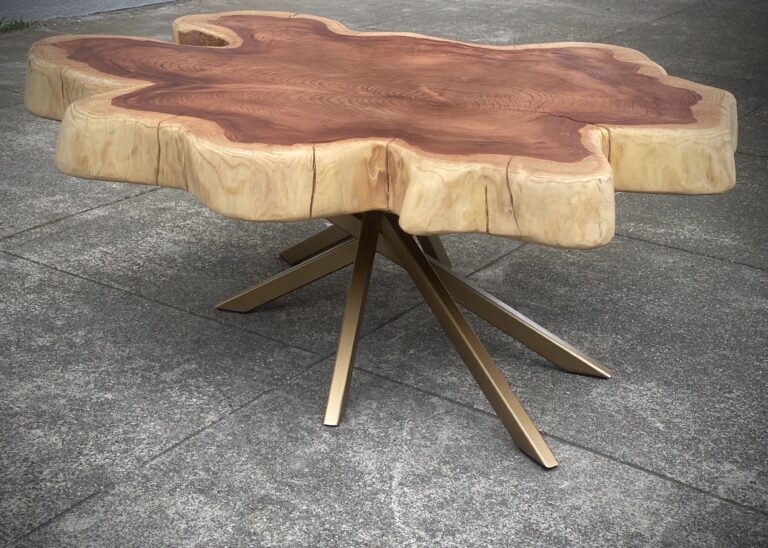 Handcrafted live edge table in Ottawa made from a natural tree slice with bold grain patterns and golden metal legs.