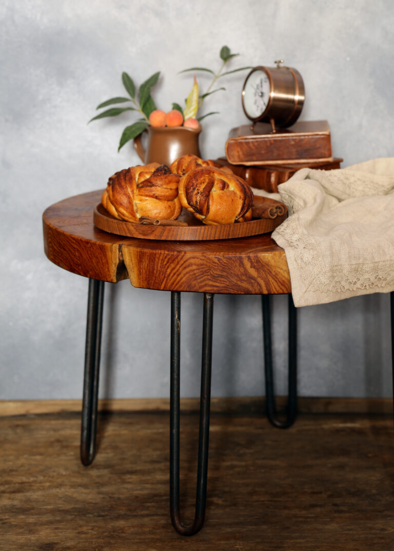 Handcrafted live edge table in Ottawa with baked goods, vintage clock, and rustic décor accents.